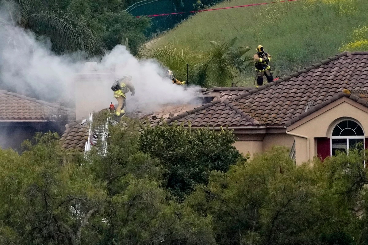 Firefighters work at the site of a plane crash in the Wood Ranch section of Simi Valley, Calif., on Saturday, May 3, 2025. (AP Photo/Mark J. Terrill)