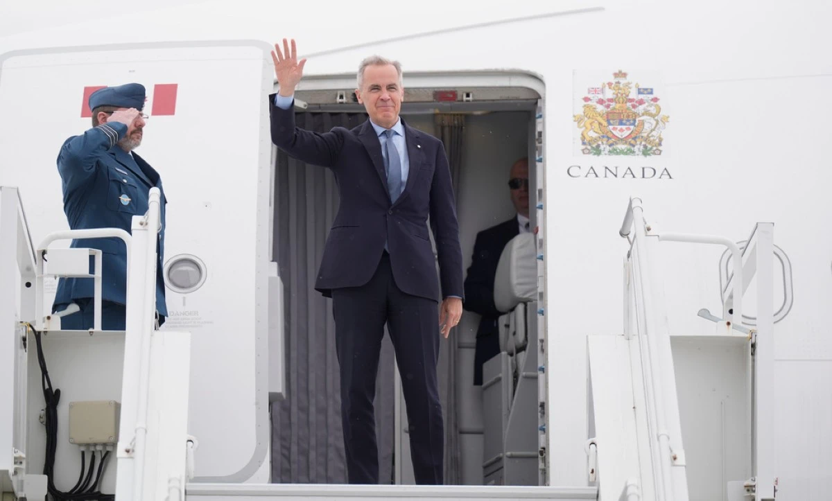 Canadian Prime Minister Mark Carney boards a government plane in Ottawa, Ontario, Monday, May 5, 2025, en route to Washington for a meeting with U.S. President Donald Trump on Tuesday. (Adrian Wyld/The Canadian Press via AP)