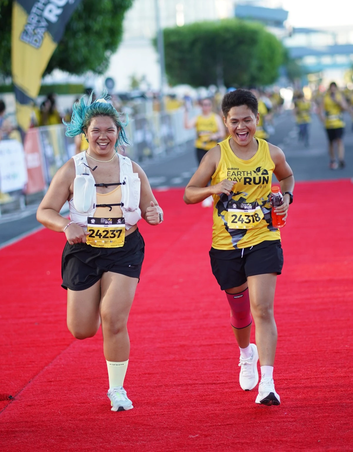 Pushing through with determination and excitement, runners take the red carpet to cross the finish line. 
