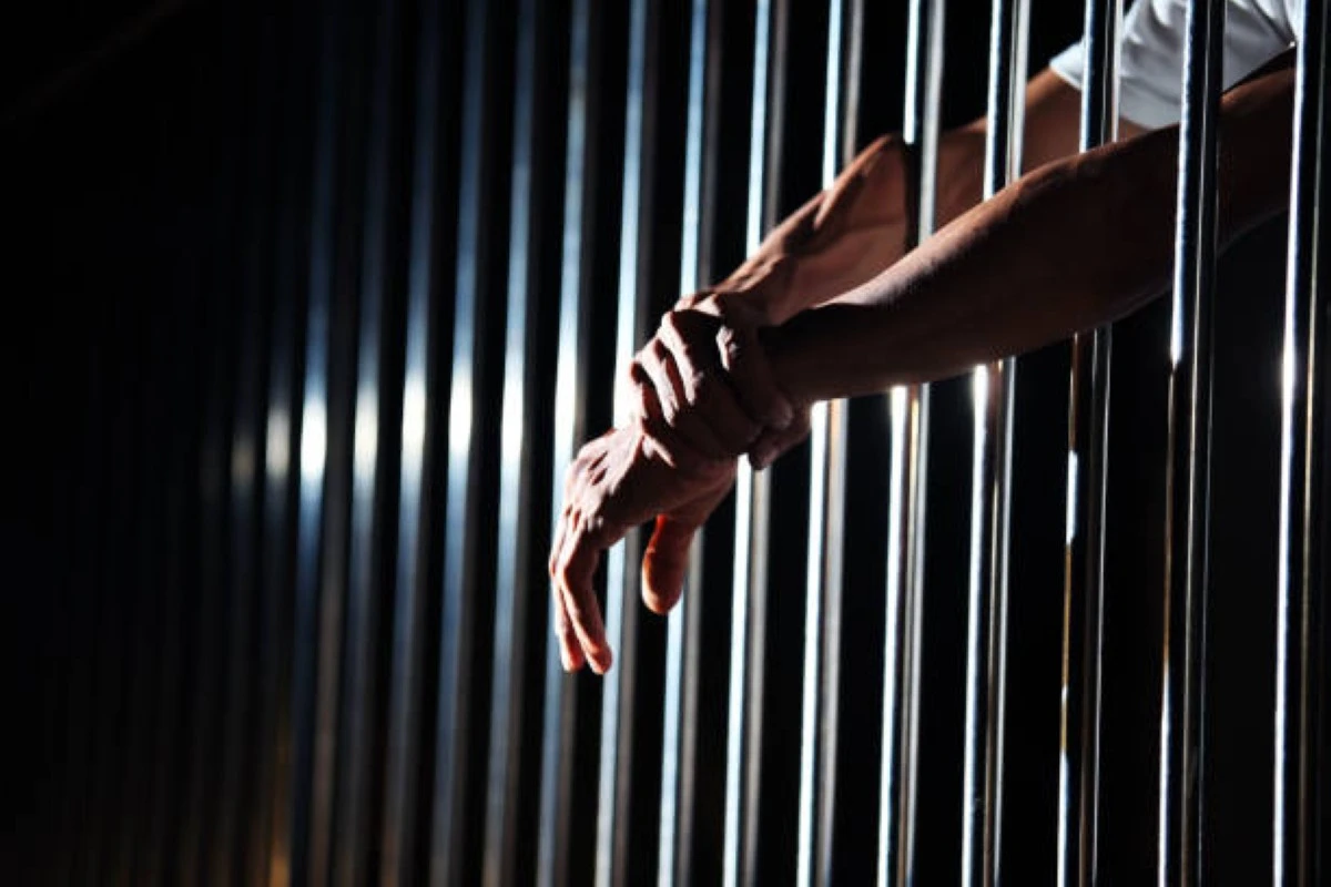 close up of hand in jail background.