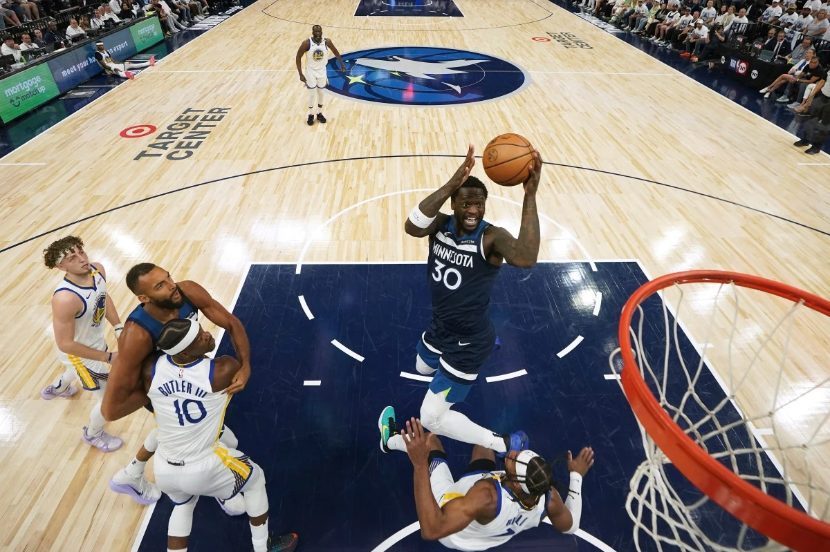 Minnesota Timberwolves forward Julius Randle (30) goes up for a shot as Golden State Warriors guard Buddy Hield (7) defends during the first half of Game 2 of an NBA basketball second-round playoff series, Thursday, May 8, in Minneapolis. (AP Photo/Abbie Parr)
