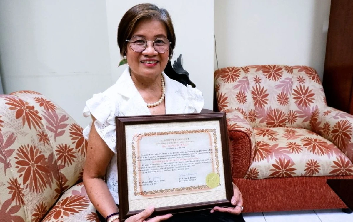 Angustia S. Segubre holds her Augustinian Affiliate certificate signed by then Cardinal Robert Prevost in 2012 (Carla Bauto Deña/MANILA BULLETIN)
