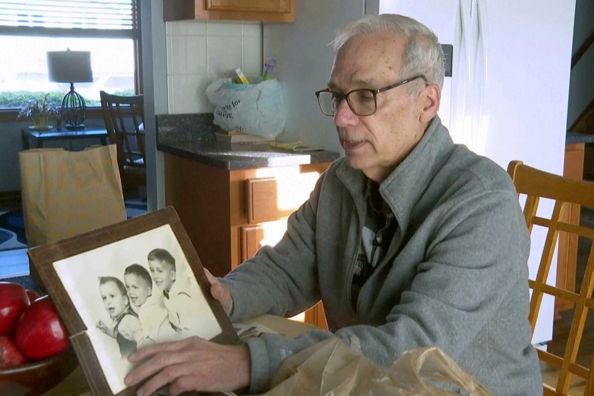 John Prevost points to an old photo of his brothers, including the newly elected Pope Leo XIV, Robert Prevost, left, during an interview with the Associated Press on Thursday, May 8, 2025, in New Lennox, Ill. (AP Photo/Obed Lamy)