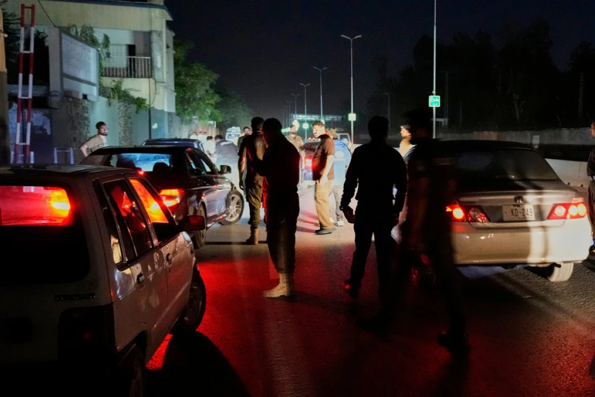 Pakistani police officers remove vehicles and people from the main entry of Nur Khan airbase following an Indian missile strike in Rawalpindi, Pakistan, Saturday, May 10, 2025. (AP Photo/Anjum Naveed)