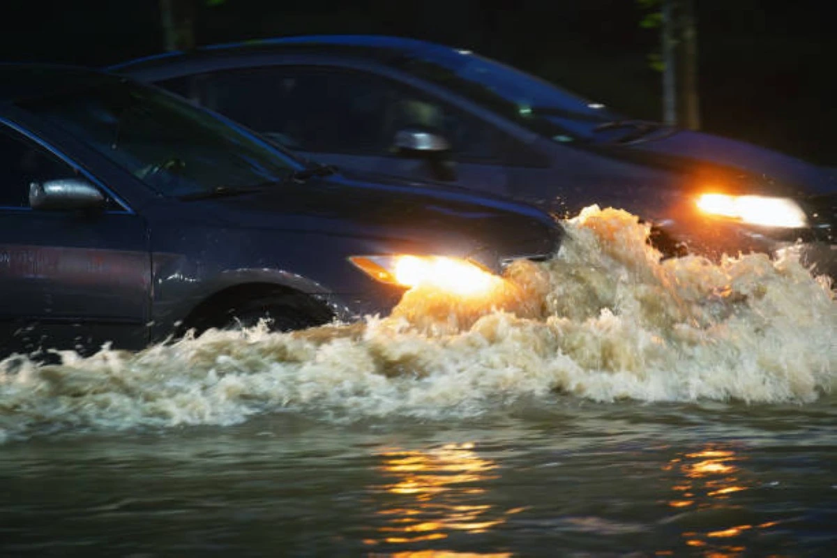Cars drive through flood waters after record setting rainfall.