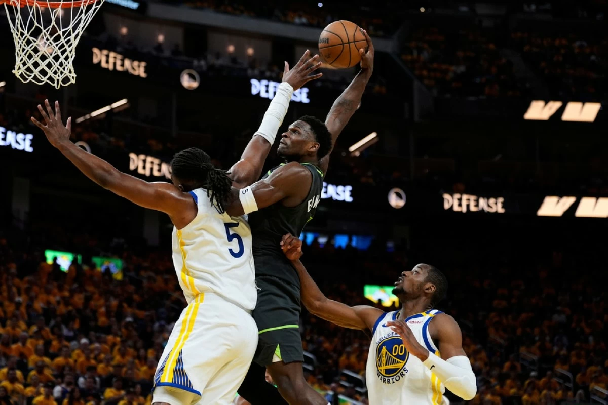 Minnesota Timberwolves guard Anthony Edwards, center, dunks over Golden State Warriors center Kevon Looney (5) during the second half of Game 3 of an NBA basketball second-round playoff series Saturday, May 10, 2025, in San Francisco. (AP Photo/Godofredo A. Vásquez)