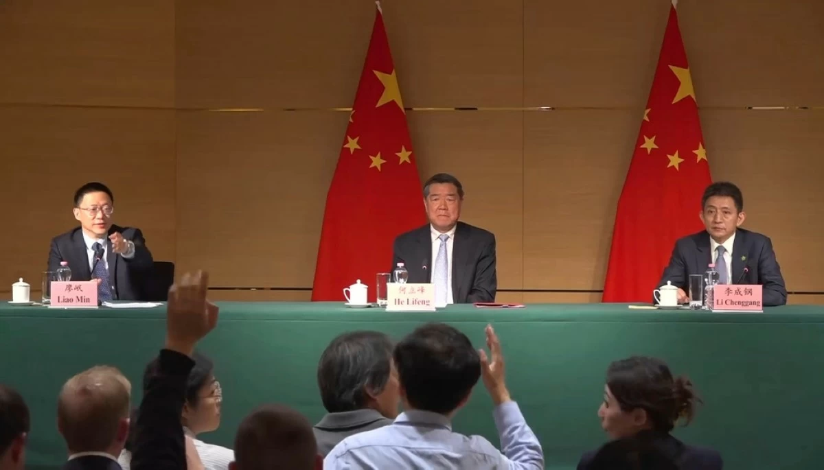 Vice minister of Finance Liao Min, left, gestures toward a journalist at a news conference at the Chinese mission to the World Trade Organization in Geneva, Switzerland, Sunday, May 11, 2025, alongside Vice Premier He Lifeng and Li Chenggang, vice minister of commerce. (AP Photo/Jamey Keaten)