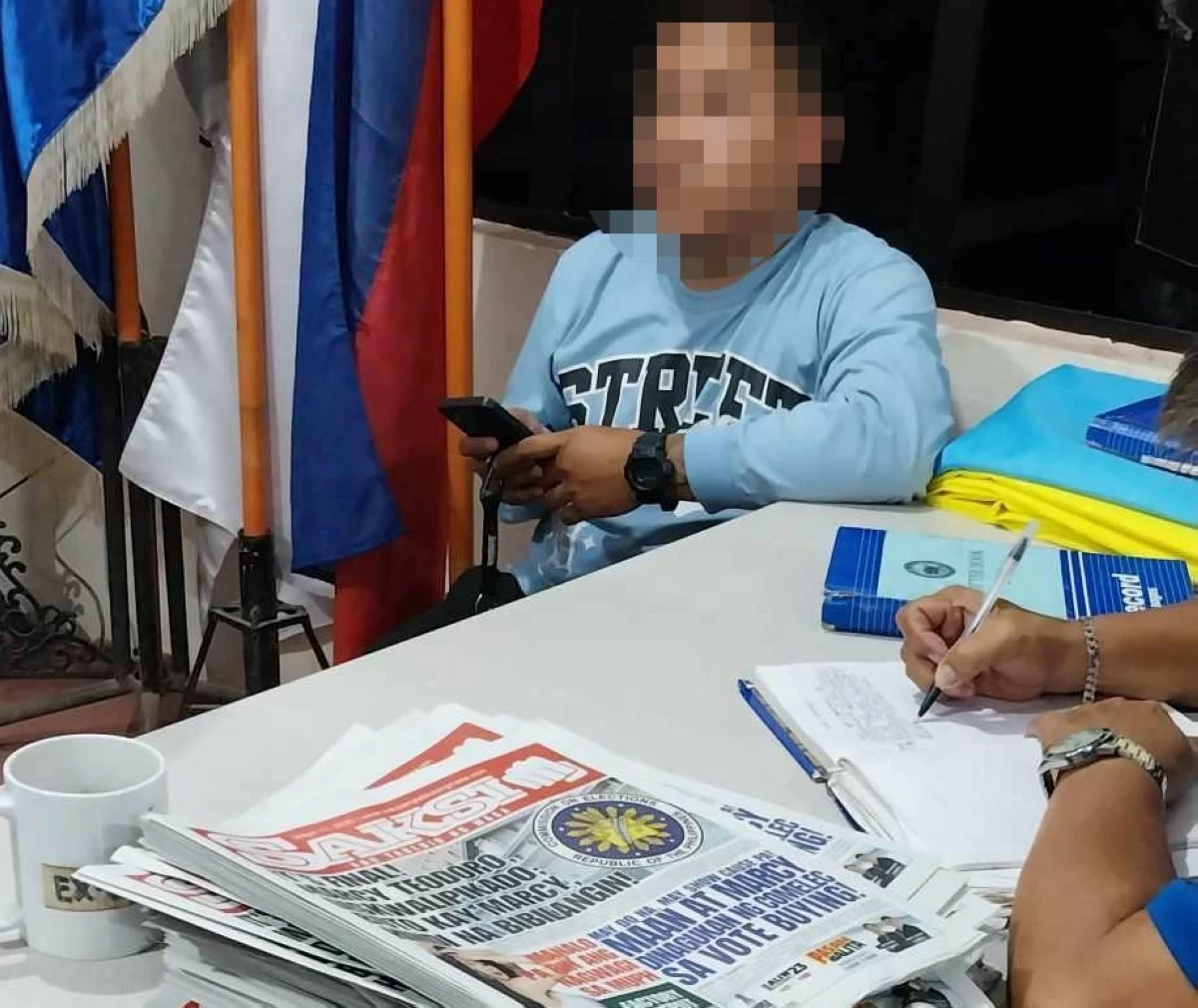 A man was arrested for distributing a tabloid containing propaganda against Mayor Marcy Teodoro and Rep. Maan Teodoro in Marikina on Monday, May 12. (Contributed photos)