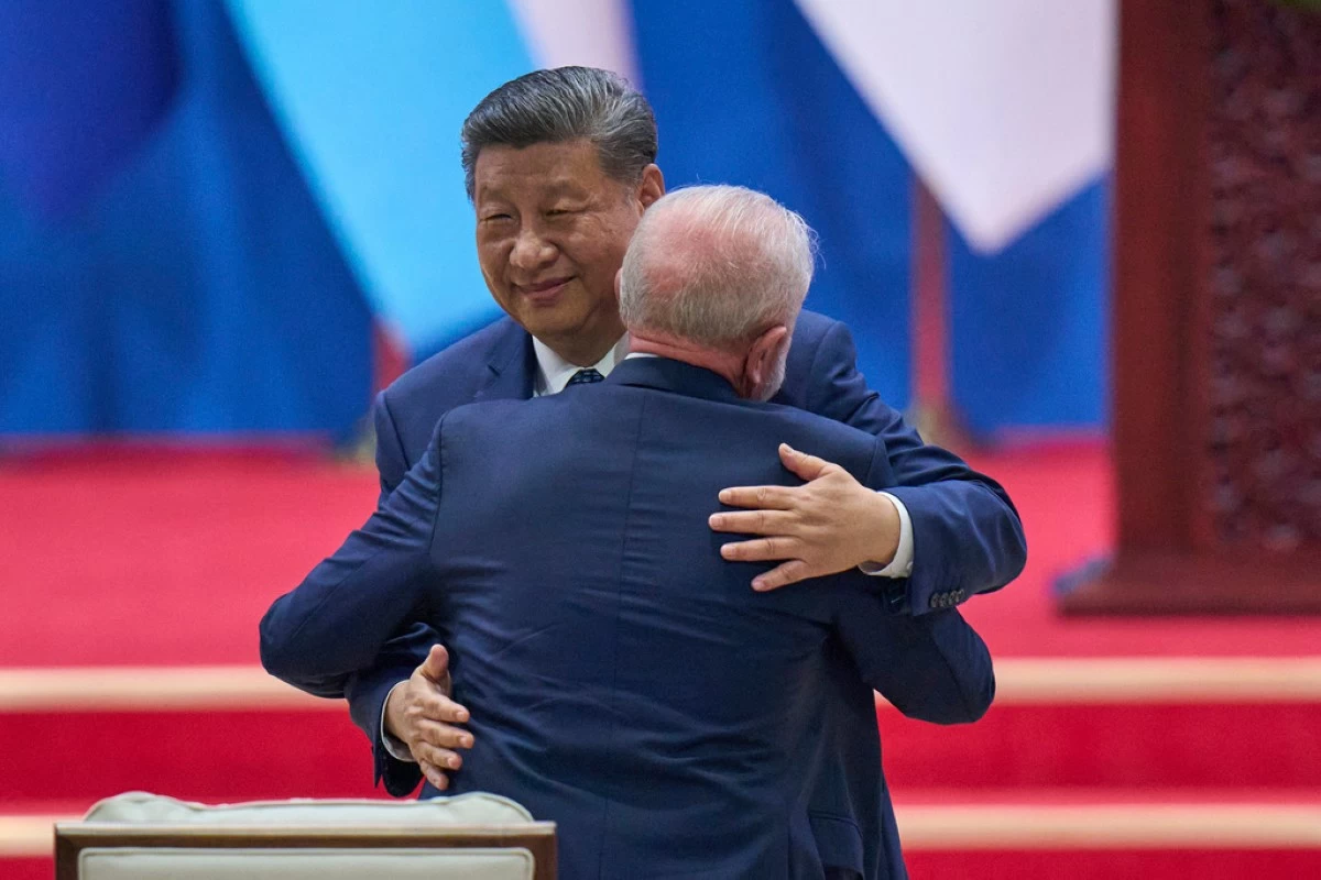 Chinese President Xi Jinping hugs Brazilian President Luiz Inacio Lula da Silva after delivering his opening speech for the opening ceremony of the Fourth Ministerial Meeting of the Forum of China and Community of Latin American and Caribbean States at China National Convention Center in Beijing, Tuesday, May 13, 2025. (AP Photo/Andy Wong)
