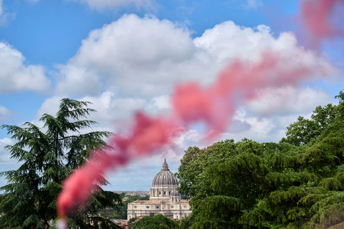 FILE - Pink smoke rises in front of St. Peter's Basilica during a protest by the Women's Ordination Conference calling for full equality for women in the Catholic Church on the first day of the conclave to elect the 267th pope in Rome on Wednesday, May 7, 2025. (AP Photo/Bernat Armangue, File)