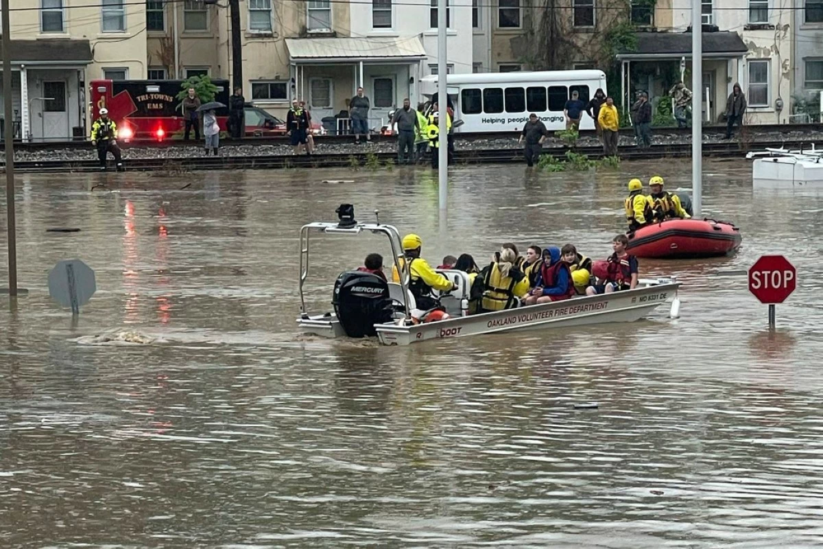 In a photo provided by Alley and Tim Wade, students are being rescued by boat after flash flooding in Westernport, MD., Tuesday, May 13, 2025. (Alley and Tim Wade via AP)