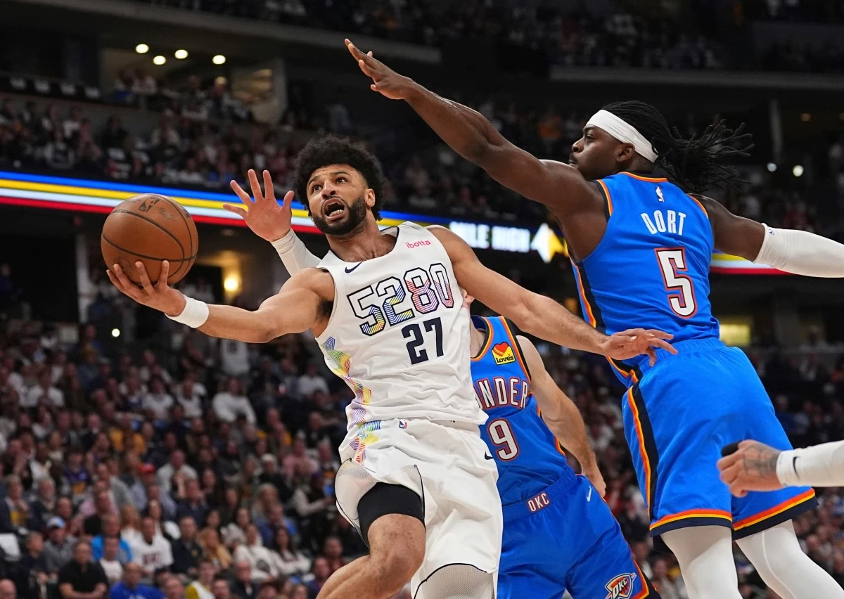 Denver Nuggets guard Jamal Murray, front left, drives to the basket as Oklahoma City Thunder guards Alex Caruso, back left, and Luguentz Dort defend in the first half of Game 6 in the Western Conference semifinals of the NBA basketball playoffs Thursday, May 15, 2025, in Denver. (AP Photo/David Zalubowski)