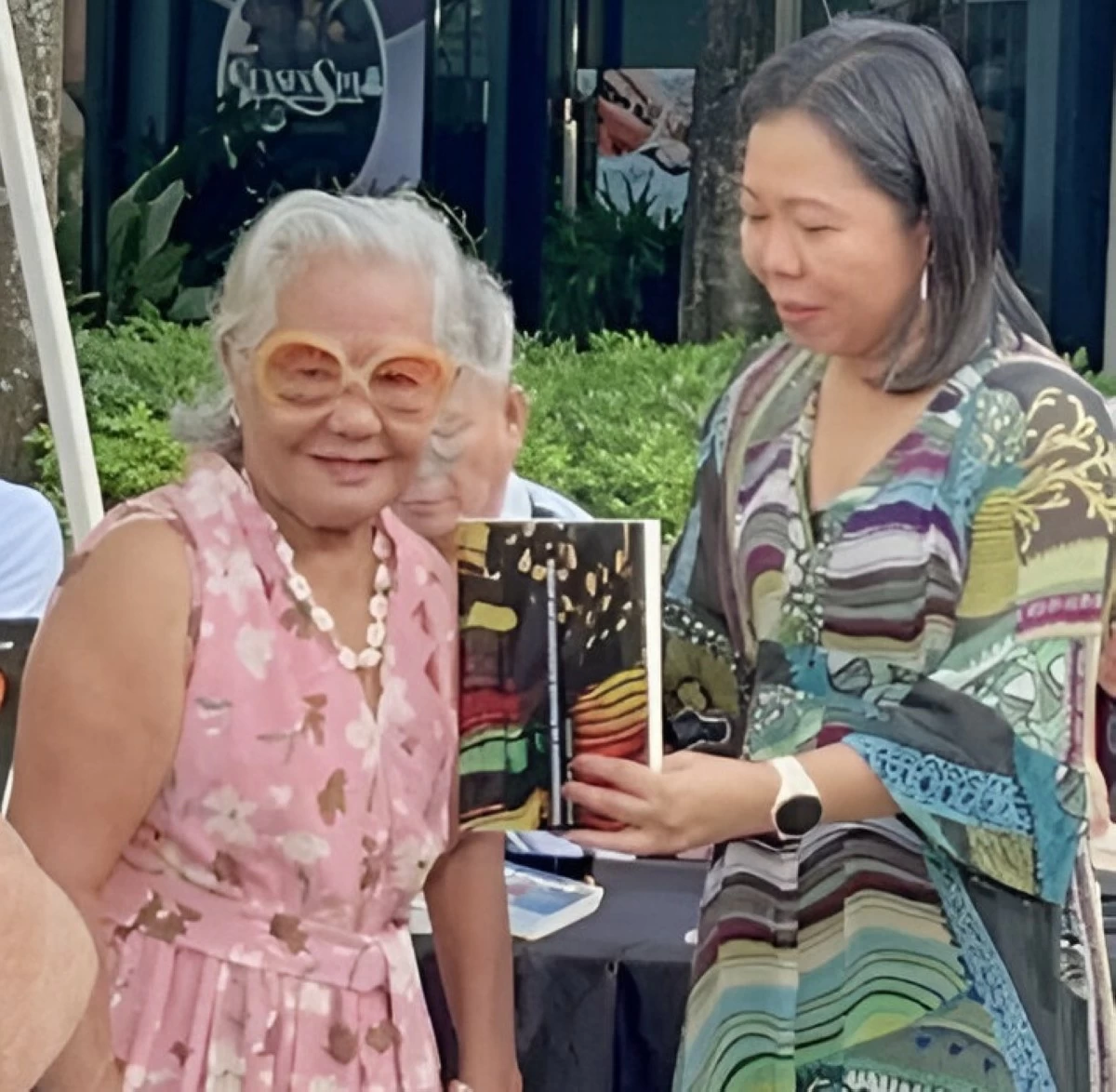 Genevieve presents her mother with a copy of the book during the launch at the Iloilo Mega Book Fair last April 13 in Iloilo City. (Photo by Jeanette Suello)