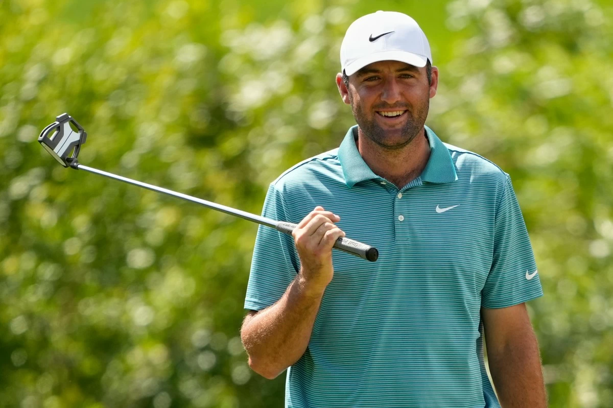 Scottie Scheffler smiles on the seventh hole during the third round of the PGA Championship golf tournament at the Quail Hollow Club, Saturday, May 17, 2025, in Charlotte, N.C. (AP Photo/Matt York)