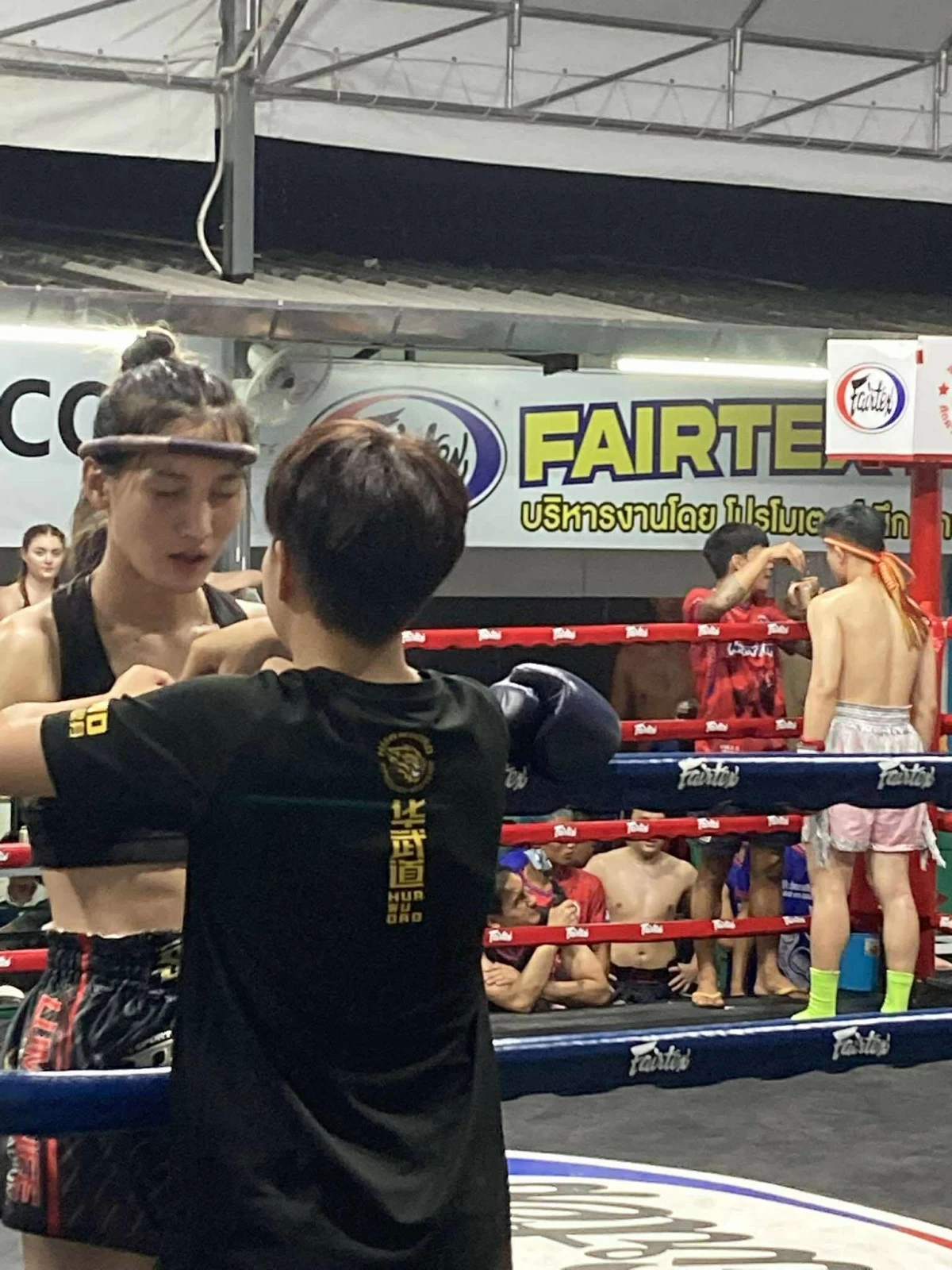 FIGHT NIGHT One of the competing Muay Thai boxers, who goes by the name of 'Ladyboy,' puts up quite a fight against their opponent.