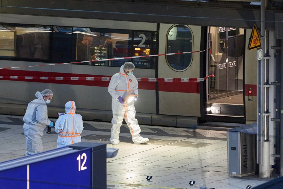 Investigators work at Hamburg, Germany's Central Station on Friday, May 23, 2025, after several people were injured in a knife attack. (Georg Wendt/dpa via AP)