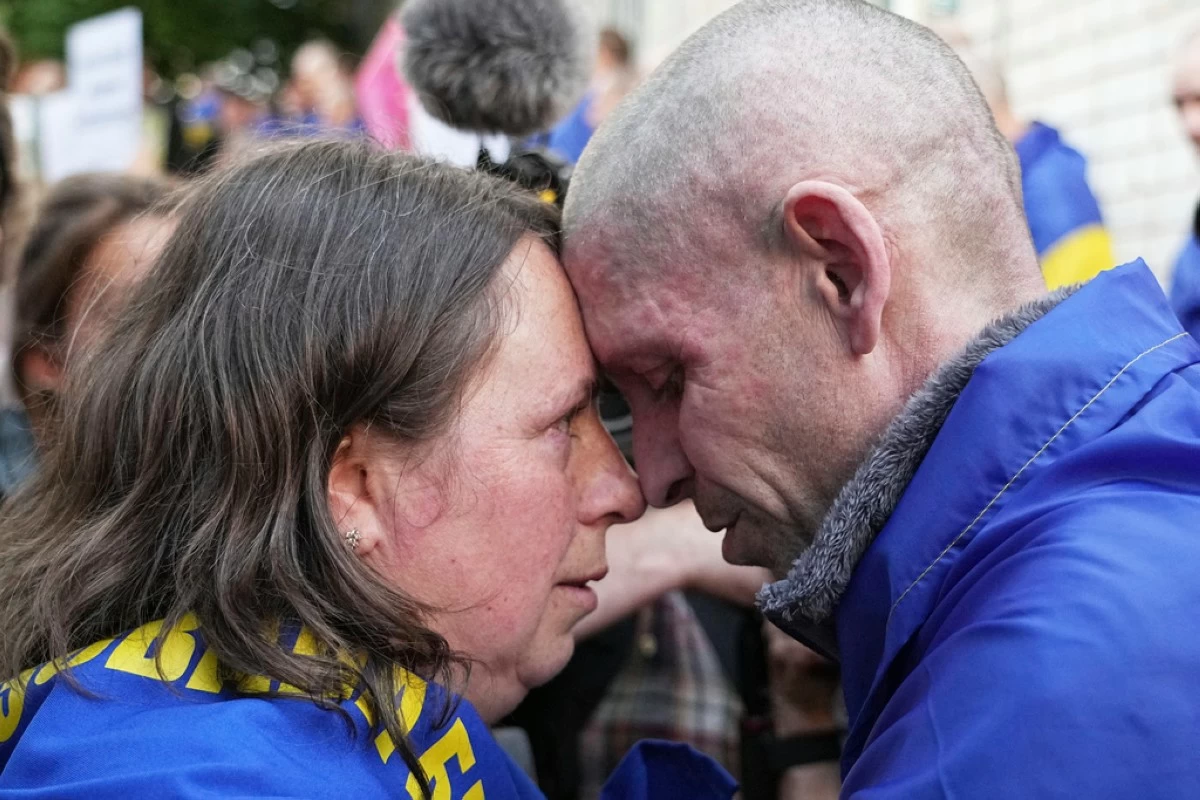 A Ukrainian serviceman Alexander, 45, hugs his wife Elena, 39, after returning from captivity during a POWs exchange between Russia and Ukraine, in Chernyhiv region, Ukraine, Friday, May 23, 2025. (AP Photo/Efrem Lukatsky)