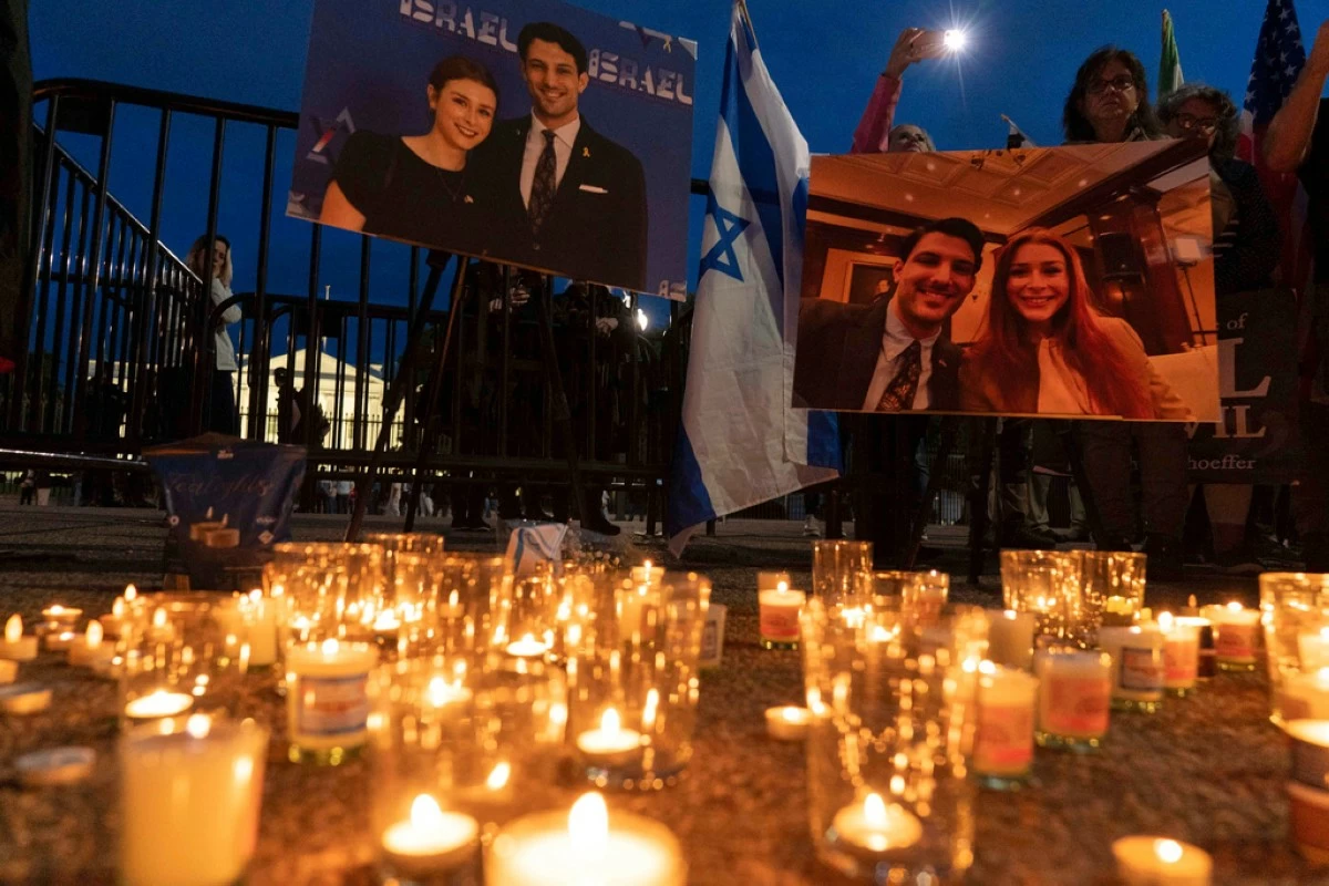 FILE - People gather to light candles in a makeshift memorial to honor Yaron Lischinsky and Sarah Milgrim who were killed as they left an event at the Capital Jewish Museum in Washington, during a candlelight vigil outside of the White House in Washington, Thursday, May 22, 2025. (AP Photo/Jose Luis Magana, file)