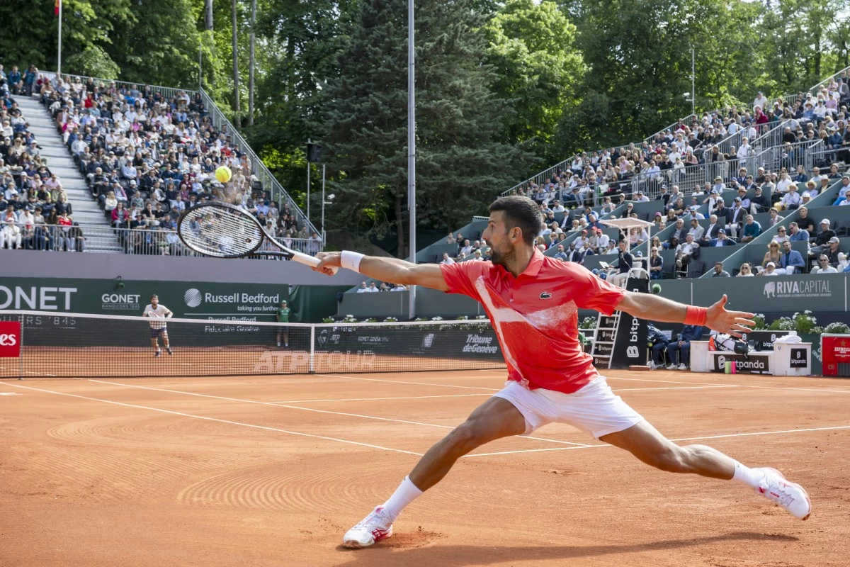 Novak Djokovic, of Serbia, returns a ball to Cameron Norrie of Britain, during their semi-final match, at the ATP 250 Geneva Open tournament in Geneva, Switzerland, Friday, May 23, 2025. (Martial Trezzini/Keystone via AP)