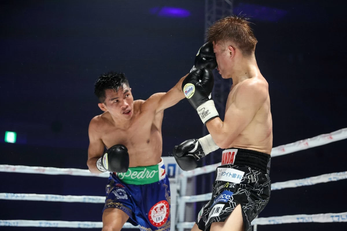 Pedro Taduran connects to Ginjiro Shigeoka during their IBF mini flyweight title bout on Saturday, May 24, in Osaka, Japan. (Wendell Alinea)