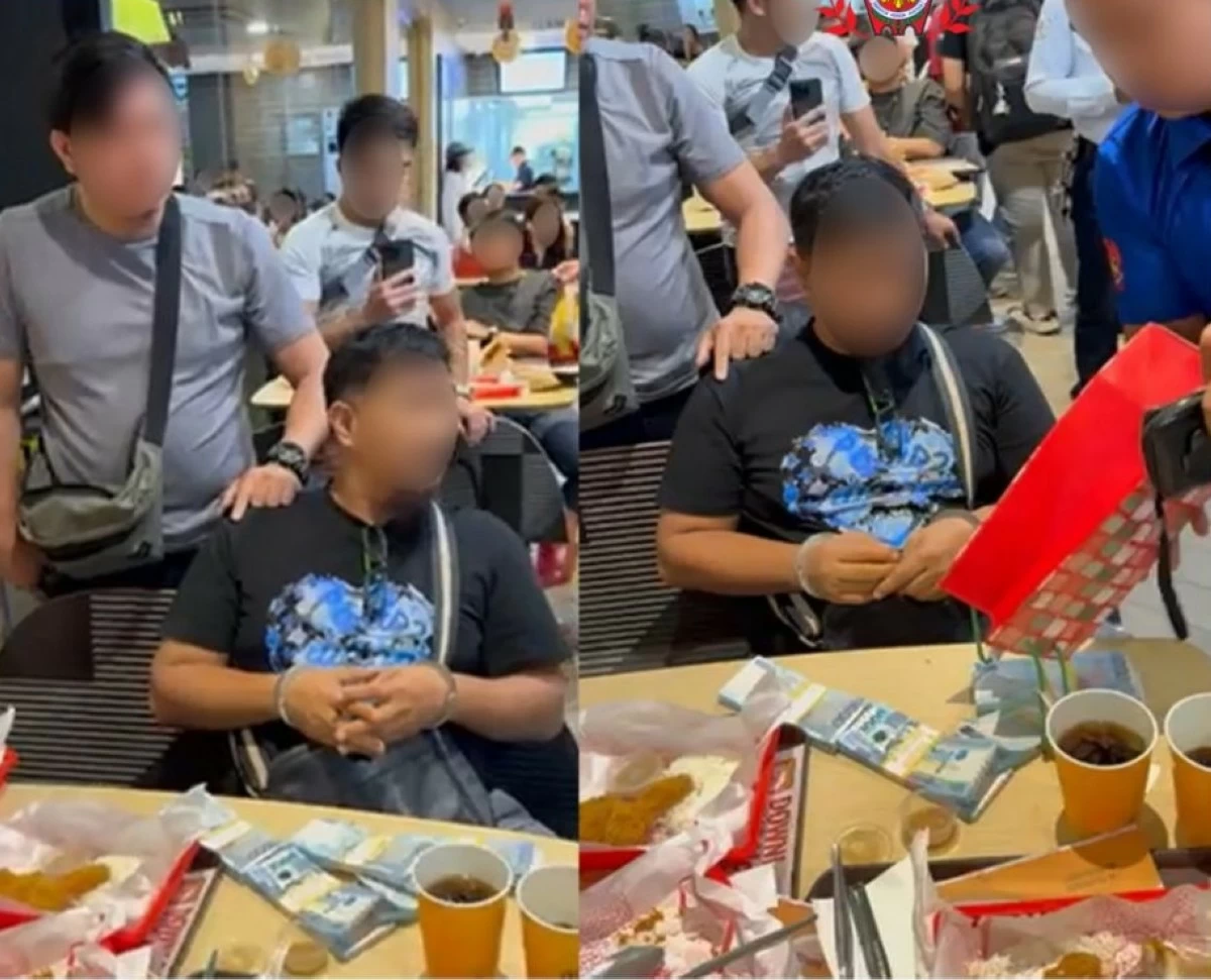 CIDG operatives identify themselves as cops to a man who was charging P350,000per applicant for an alleged assured slot at the Philippine Coast Guard recruitment in an entrapment operation in Manila. (photo: CIDG)