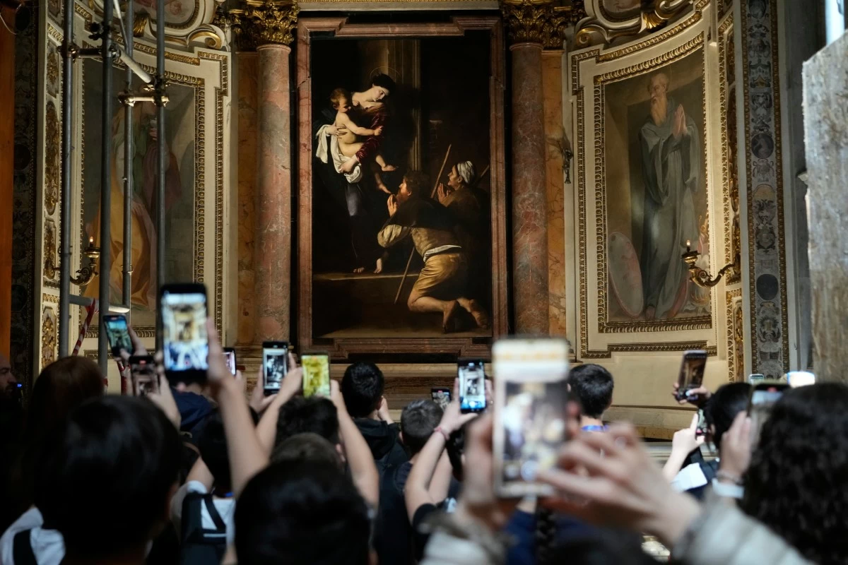 TOURISTS admire the Pilgrim’s Madonna of Caravaggio at the Basilica of Saint Augustine in Rome, Thursday, May 22, 2025. (AP)