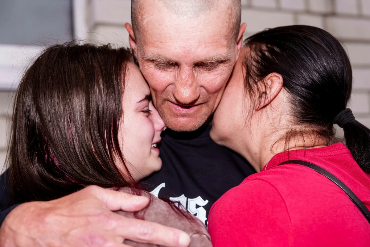A Ukrainian soldier hugs with women after returning from captivity during a POWs exchange between Russia and Ukraine, in Chernyhiv region, Ukraine, Saturday, May 24, 2025. (AP)