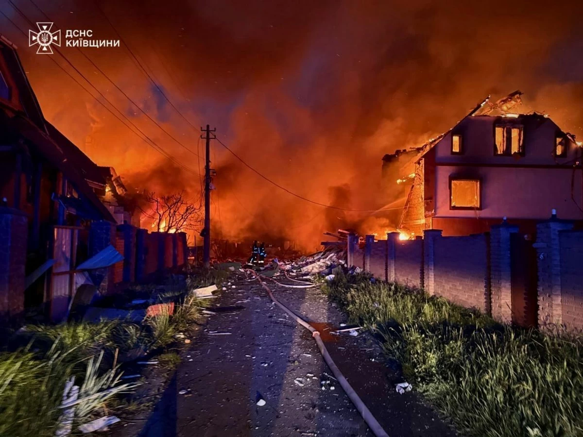 In this photo provided by the Ukrainian Emergency Service, firefighters try to put out a fire following a Russian attack in Kyiv region, Ukraine, Sunday, May 25, 2025. (Ukrainian Emergency Service via AP)