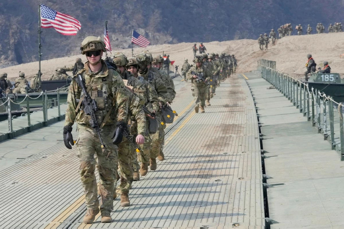 FILE - U.S. Army soldiers cross a floating bridge on the Imjin River during a joint river-crossing exercise between South Korea and the United States as a part of the Freedom Shield military exercise in Yeoncheon, South Korea, March 20, 2025. (AP Photo/Ahn Young-joon, File)