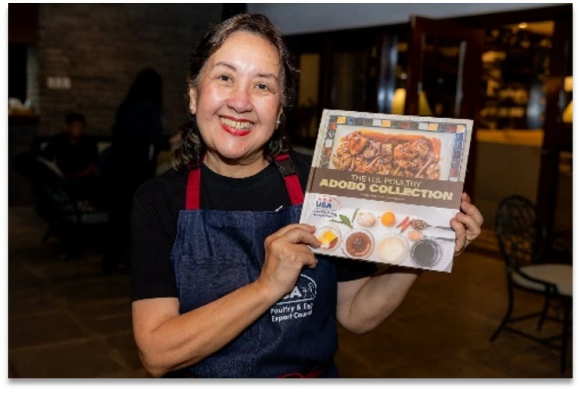 'Adobo Queen' Chef Nancy Reyes-Lumen shows a copy of the 'US Poultry Adobo Collection,' published with the support of the US Department of Agriculture’s Foreign Agricultural Service in Manila, the USA Poultry and Egg Export Council, and the United Soybean Board.