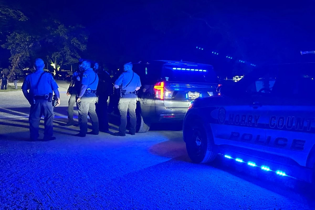 In this photo provided by the Horry County Police Department, police officers respond to the scene of a shooting on Sunday, May 25, 2025, in Little River, S.C. (Horry County Police Department via AP)