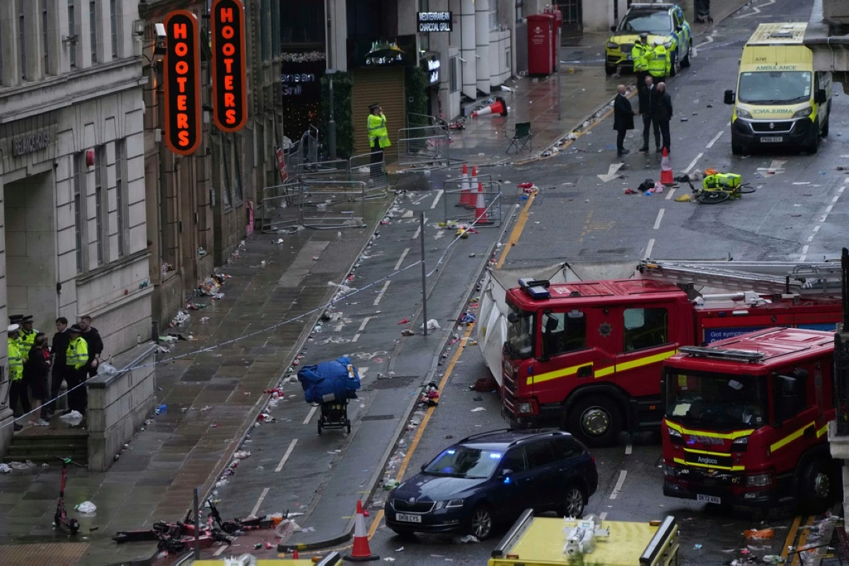 Fans leave as Police and emergency personnel deal with an incident after a car collided with pedestrians near the Liver Building during the Premier League winners parade in Liverpool, England, Monday, May 26, 2025.(AP Photo/Jon Super)