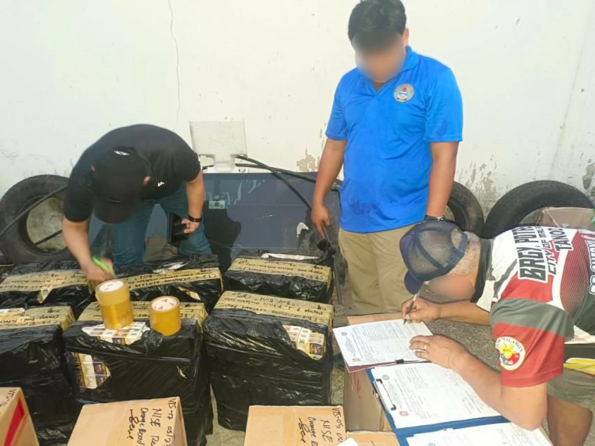 CIDG operatives and local officials conduct inventory of the counterfeit cigarettes seized during an operation in Malabon. (photo: CIDG)