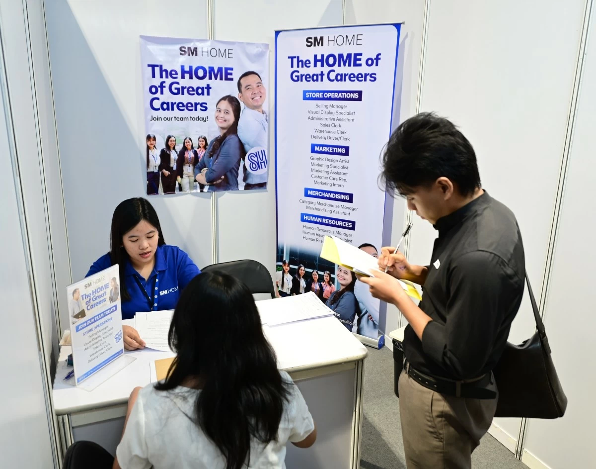 A job searcher engages with recruiters at the May 1 SM Labor Day Job Fair at the SMX Convention Center Manila, seeking new career prospects.
