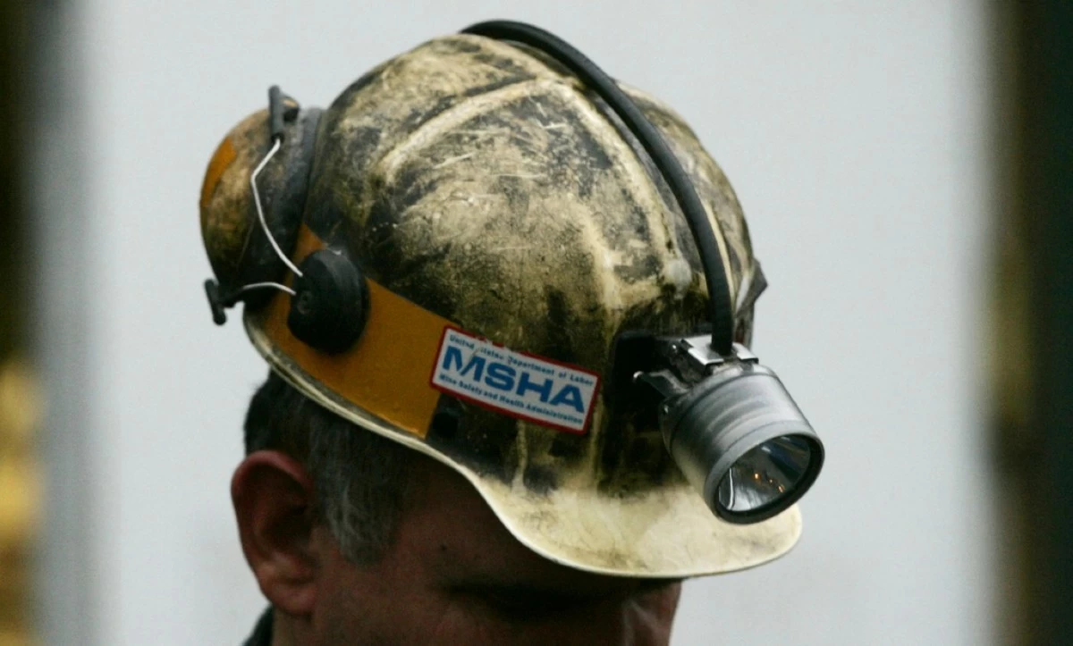 FILE - A miner gathers his thought before taking part in a rescue mission, Tuesday, Jan. 3, 2006, in Tallmansville, W.Va.. (AP Photo/Haraz N. Ghanbari, Pool, File)