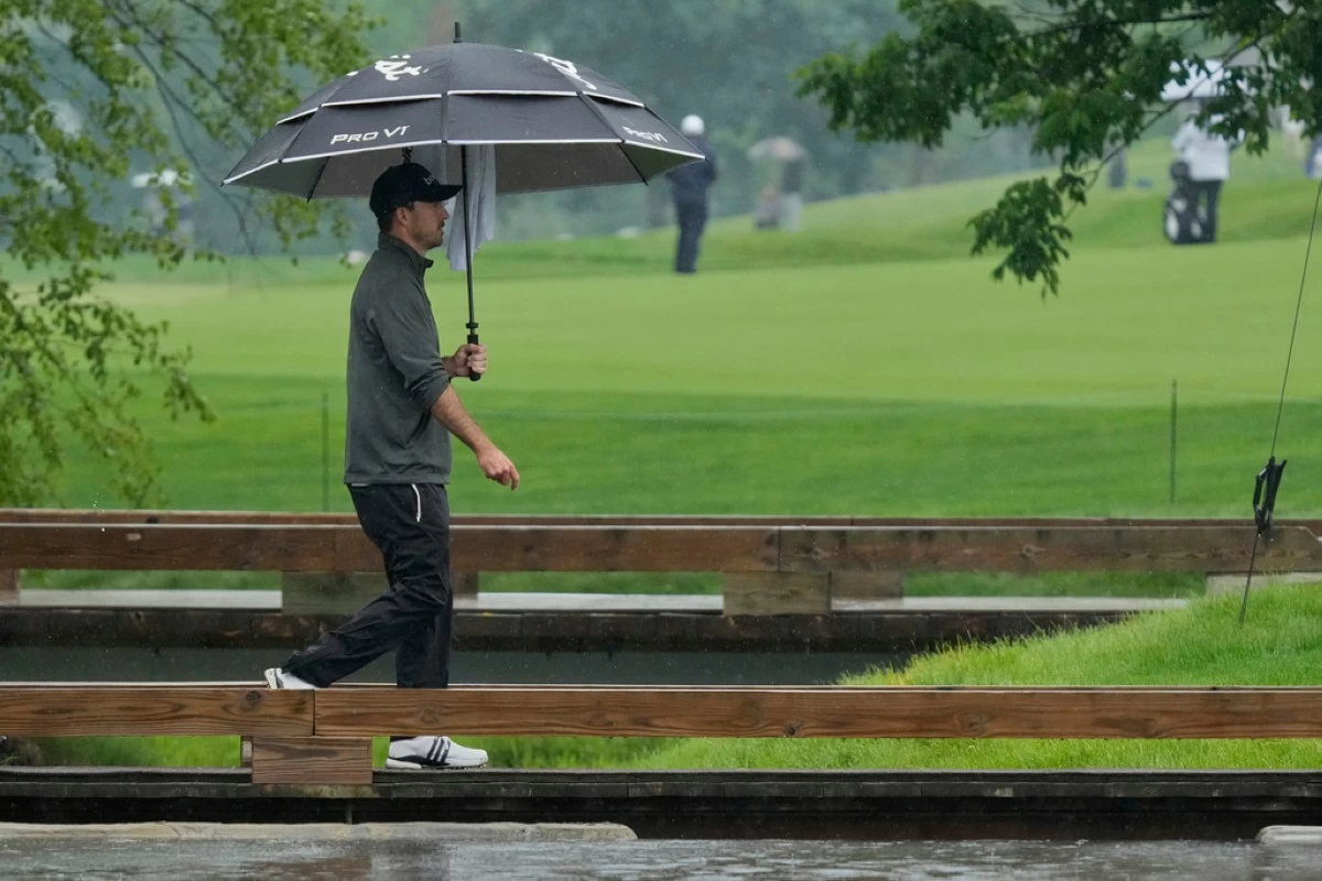 Nick Taylor walks across a bridge on the ninth hole during the second round of the Memorial golf tournament, Friday, May 30, 2025, in Dublin, Ohio. (AP Photo/Sue Ogrocki)
