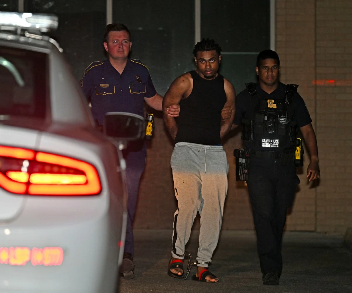 FILE - Troopers with Louisiana State Police escort Orleans Parish Prison escapee Lenton Vanburen to a waiting vehicle late Monday, May 26, 2025, at Louisiana State Police Headquarters after he was captured in Baton Rouge, La. (Hilary Scheinuk/The Advocate via AP File)