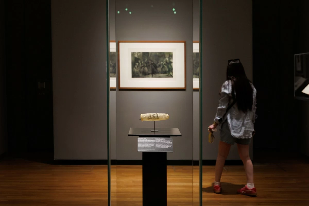 This image made available by the Rijksmueum shows a condom with print, circa 1830, displayed at Amsterdam's Rijksmuseum. (Kelly Schenk/Rijksmuseum via AP)