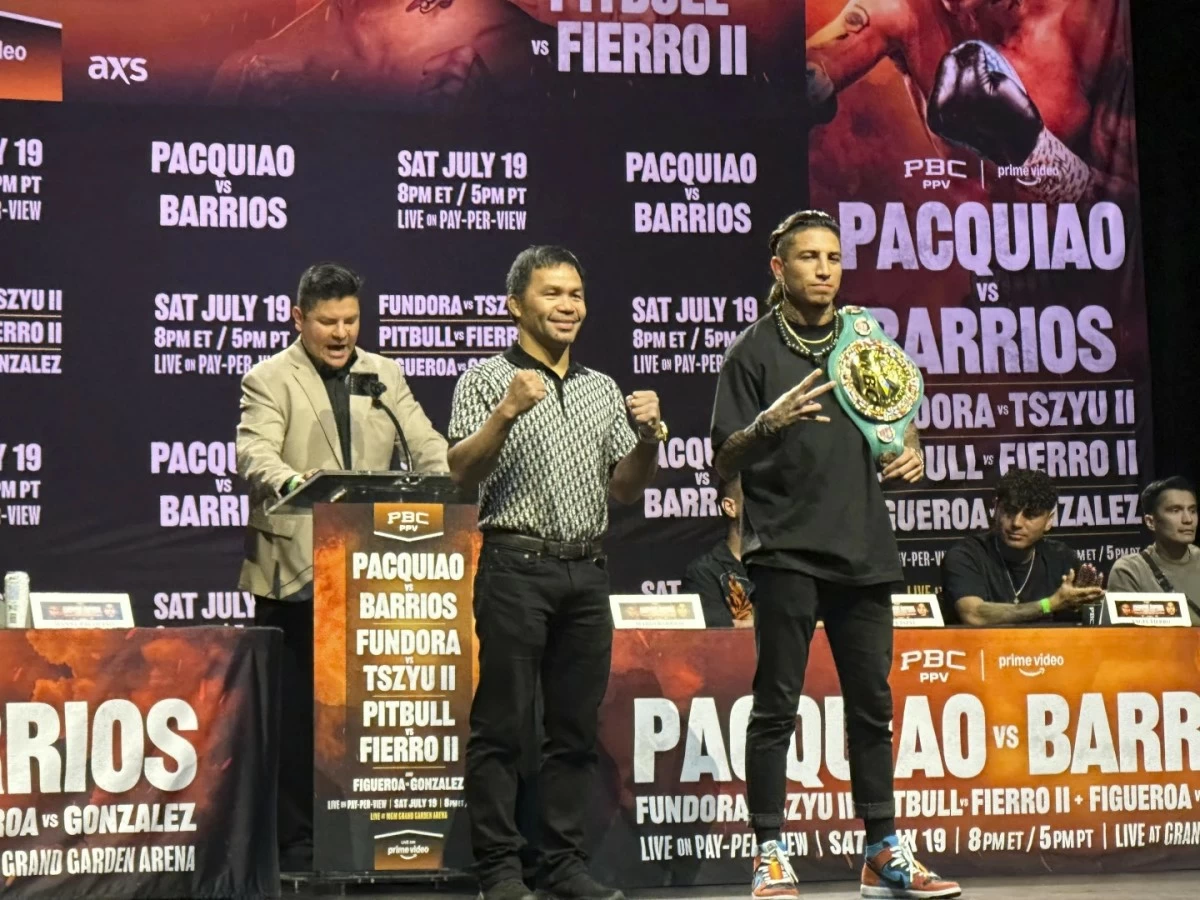 Manny Pacquiao, center, and WBC welterweight champion Mario Barrios pose at a news conference in Los Angeles on Tuesday, June 3, 2025. (AP Photo/Greg Beacham)