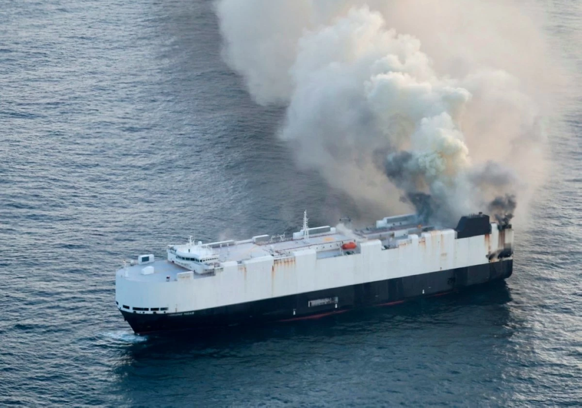In this photo provided by the U.S. Coast Guard, smoke rises from cargo vessel Morning Midas approximately 300 miles south of Adak, Alaska, June 3, 2025, as the crew of a cargo ship carrying around 3,000 vehicles to Mexico, abandoned ship after they could not control a fire. (U.S. Coast Guard/Courtesy Air Station Kodiak via AP)
