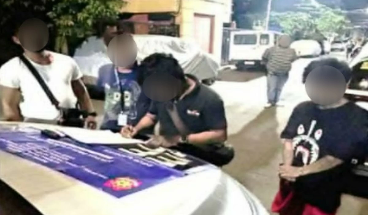 The Taguig police with the suspect (Photo from Taguig police / SPD)