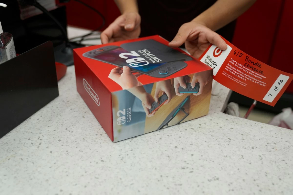 A customer receives the new Nintendo Switch 2 video game console at a Target store on Thursday, June 5, 2025 in Chicago. (AP Photo/Kiichiro Sato)