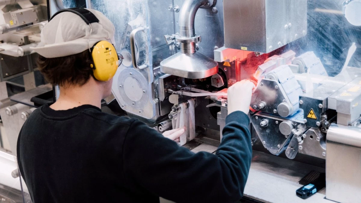 In Vargarda, Sweden, a skilled factory worker meticulously oversees the production of JTI's Nordic Spirit nicotine pouches. This precise manufacturing process ensures the high quality of this tobacco-free oral nicotine product