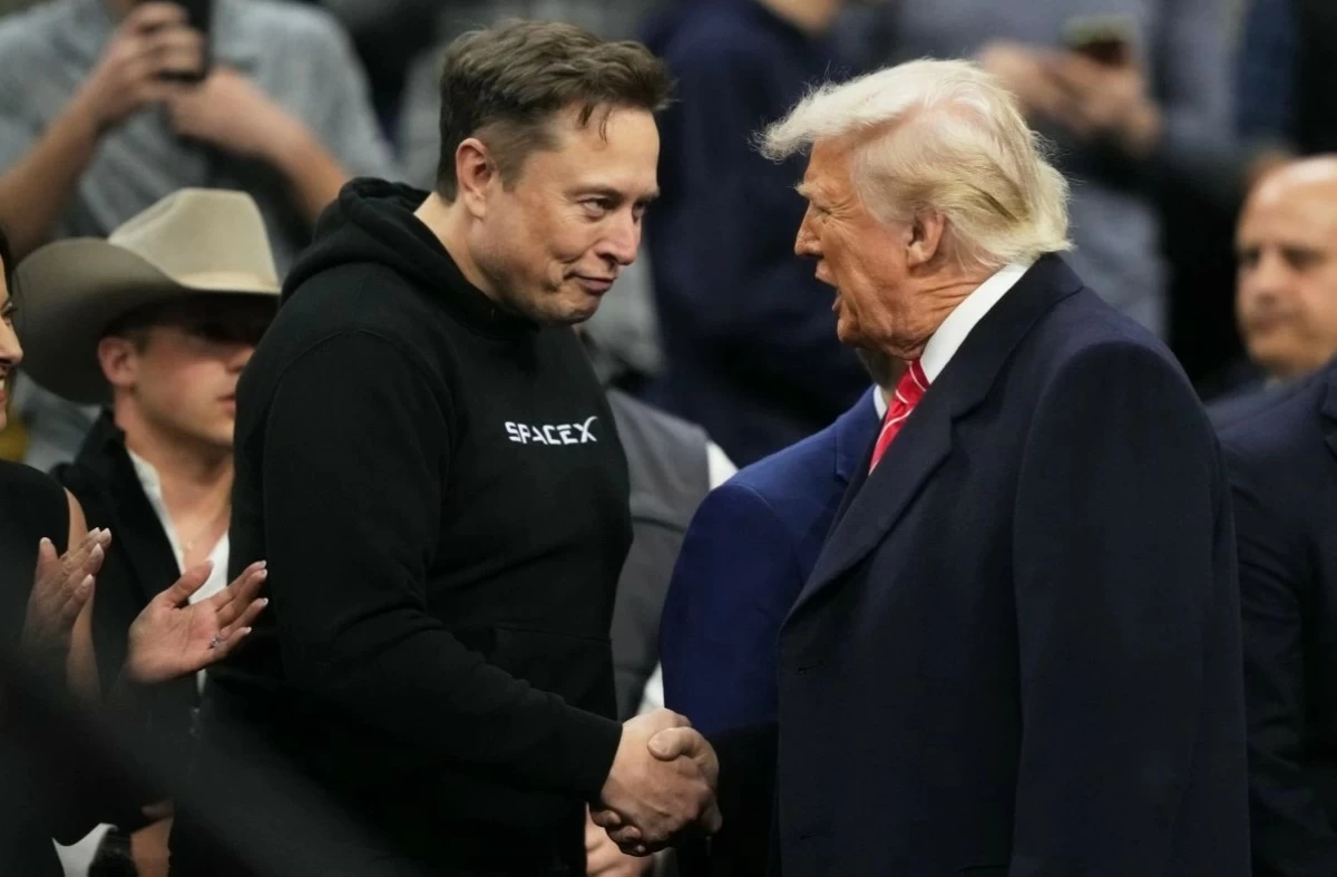ELON Musk (left) shakes hands with President Donald Trump at the finals of the NCAA wrestling championship, March 22, 2025, in Philadelphia. (AP)