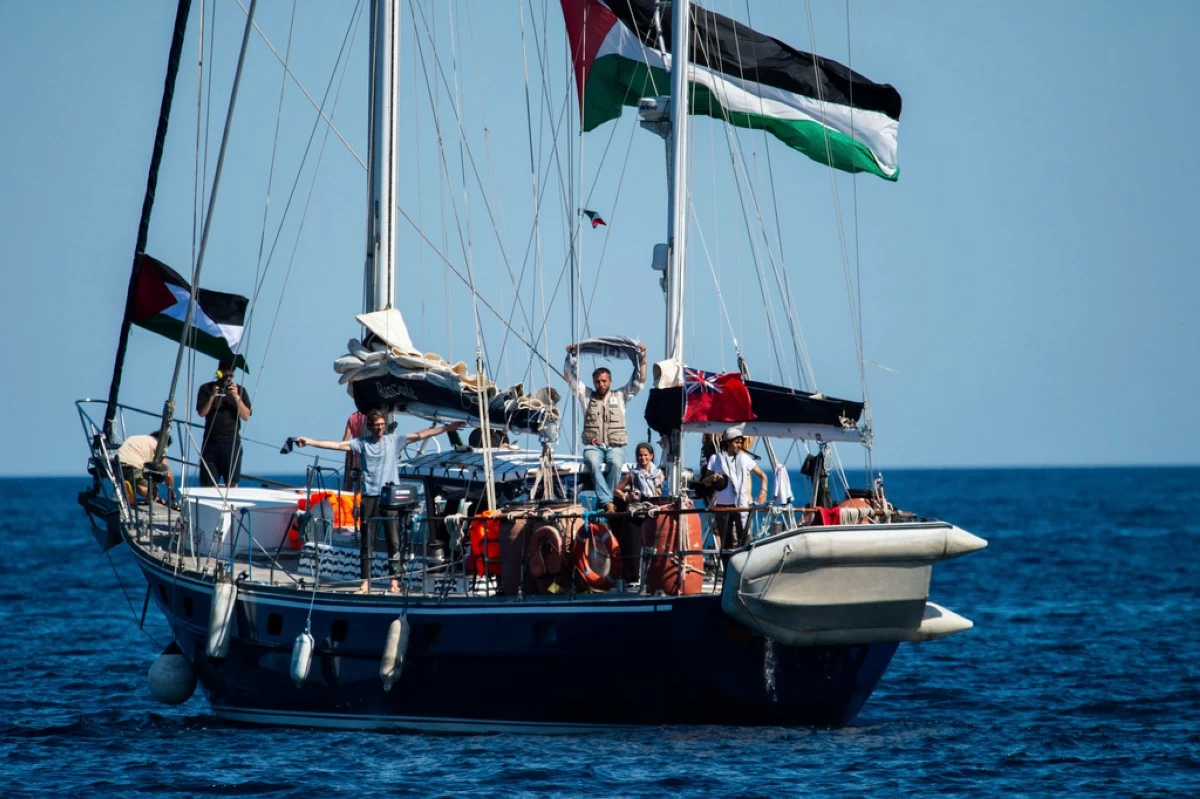 Activists of the Freedom Flotilla Coalition, board the Madleen boat, ahead of setting sail for Gaza, departing from the Sicilian port of Catania, Italy, Sunday, June 1, 2025. (AP Photo/Salvatore Cavalli)