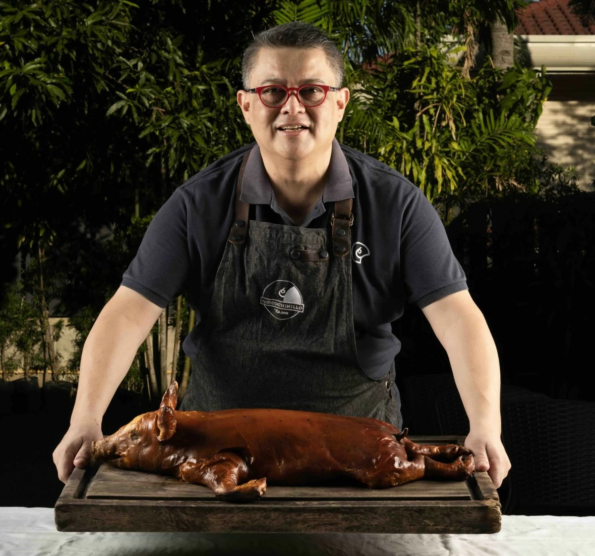 ROAST MASTER Tinee de Guzman prepares to serve his signature roast—golden, crisp, and made for gathering.