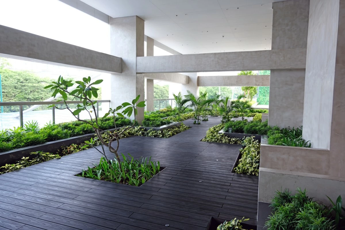 An outdoor yoga and meditation room is surrounded by greenery.