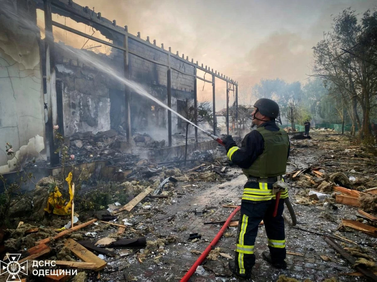 In this photo provided by the Ukrainian Emergency Service, a firefighter tackles a blaze after a Russian attack that hit a private house in Odesa region, Ukraine, Wednesday, June 11, 2025. (Ukrainian Emergency Service via AP)