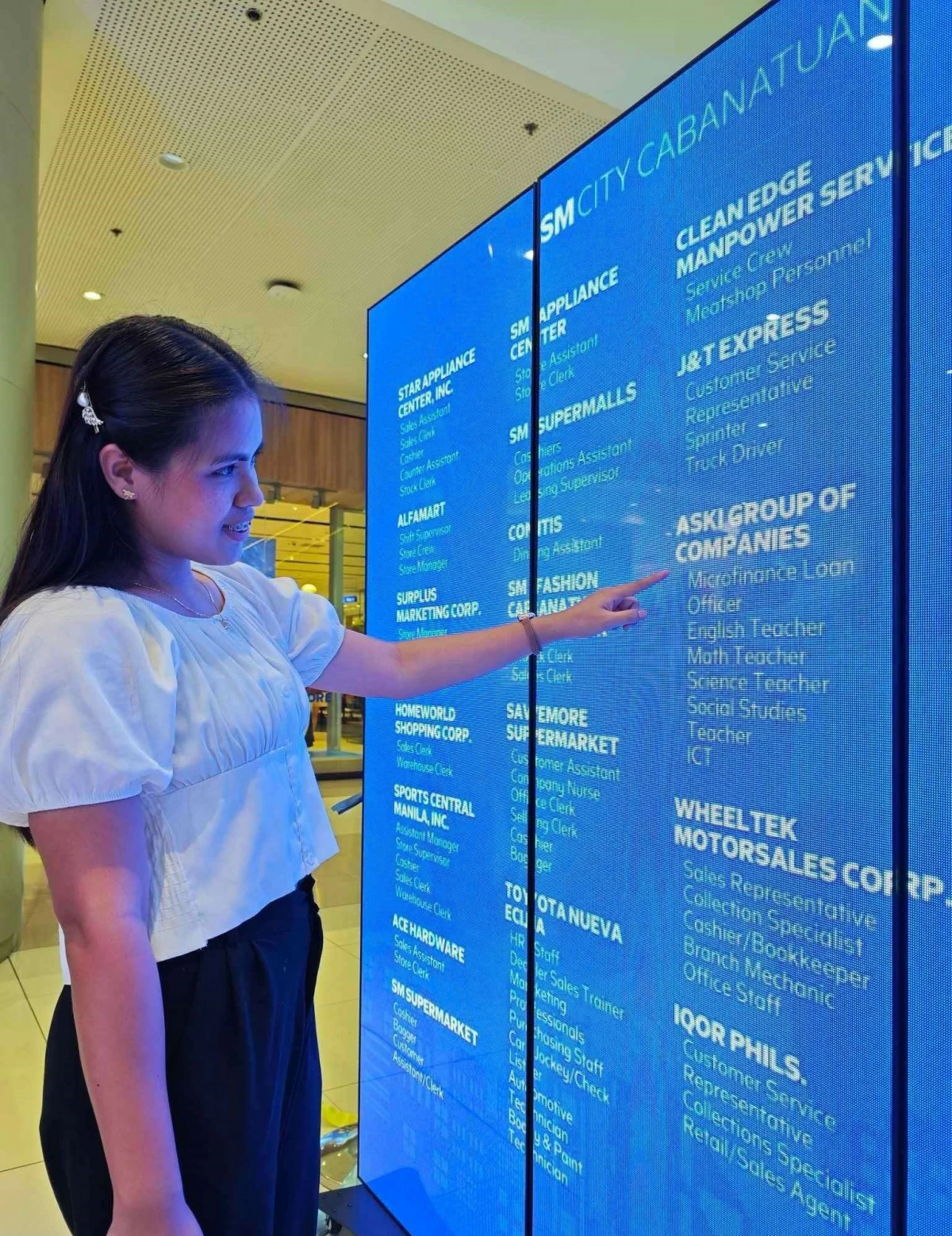 A hopeful candidate at SM City Cabanatuan reviews available opportunities on a digital board during the Job Fair.