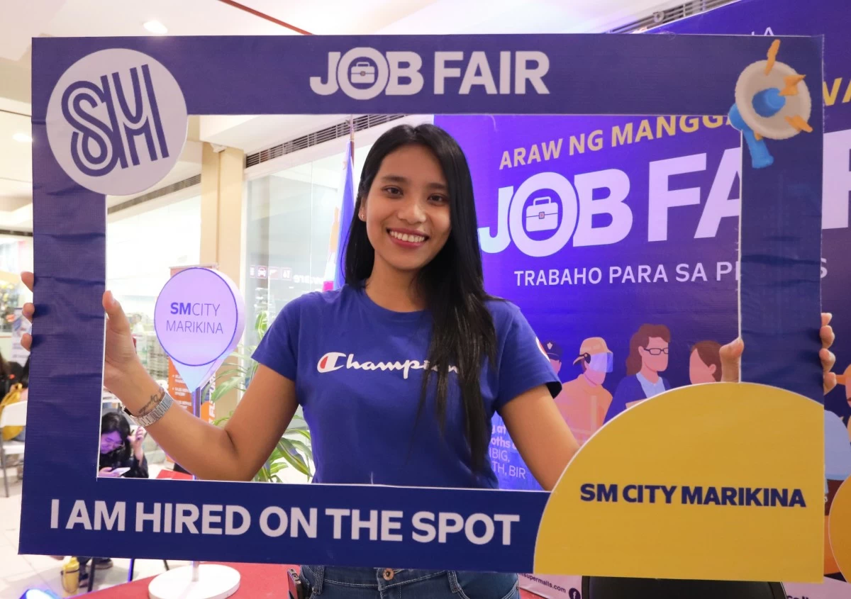 A newly hired applicant celebrates her on-the-spot achievement at the SM City Marikina Job Fair.